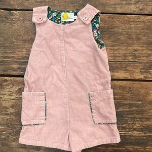 Adorable light pink Mini Boden romper with floral lining and accents.